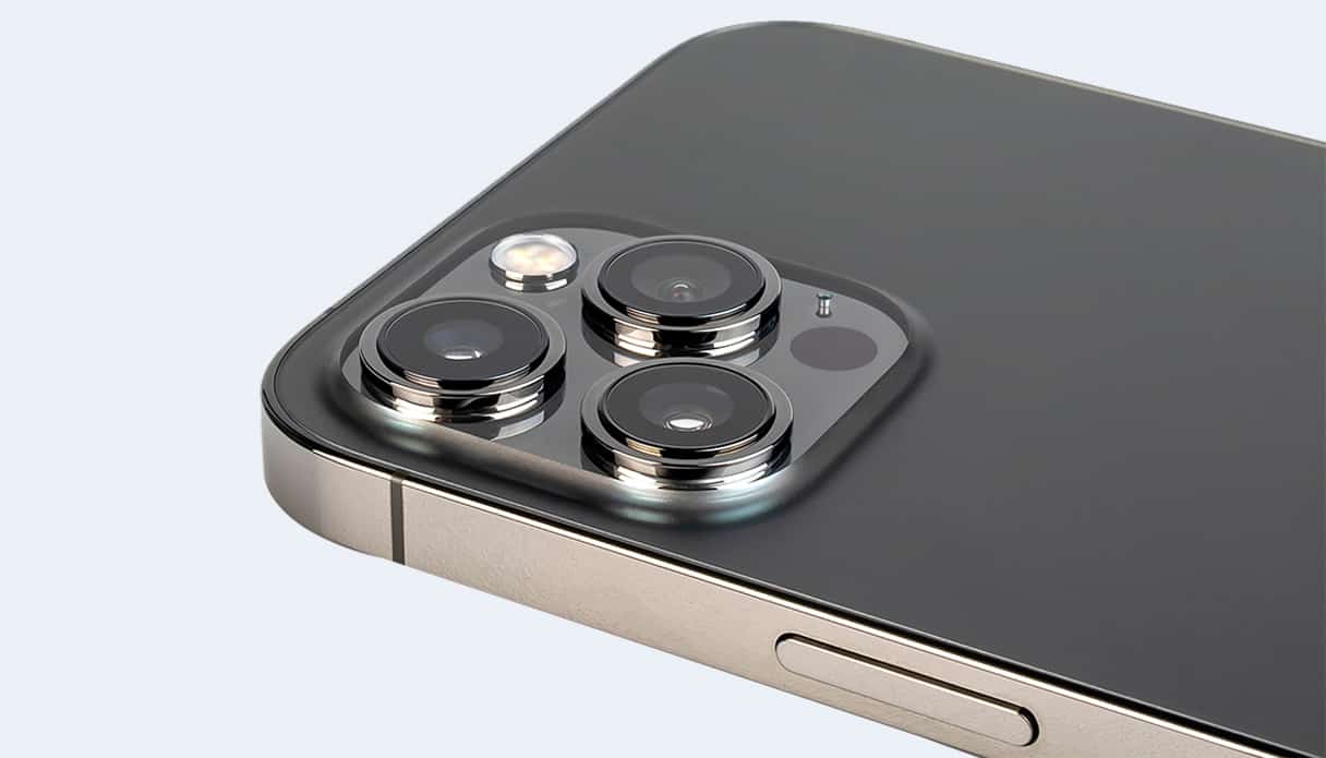 Aus dem rechten Winkel taucht ein Teil des iPhones auf, der Fokus liegt auf dem Kamera-Array des iPhones.