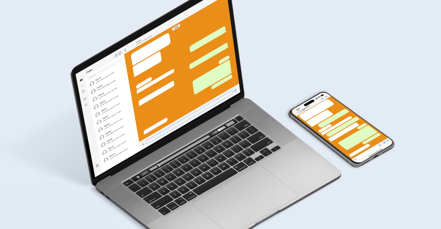 Ein Laptop und ein Telefon, auf denen WhatsApp geöffnet ist.